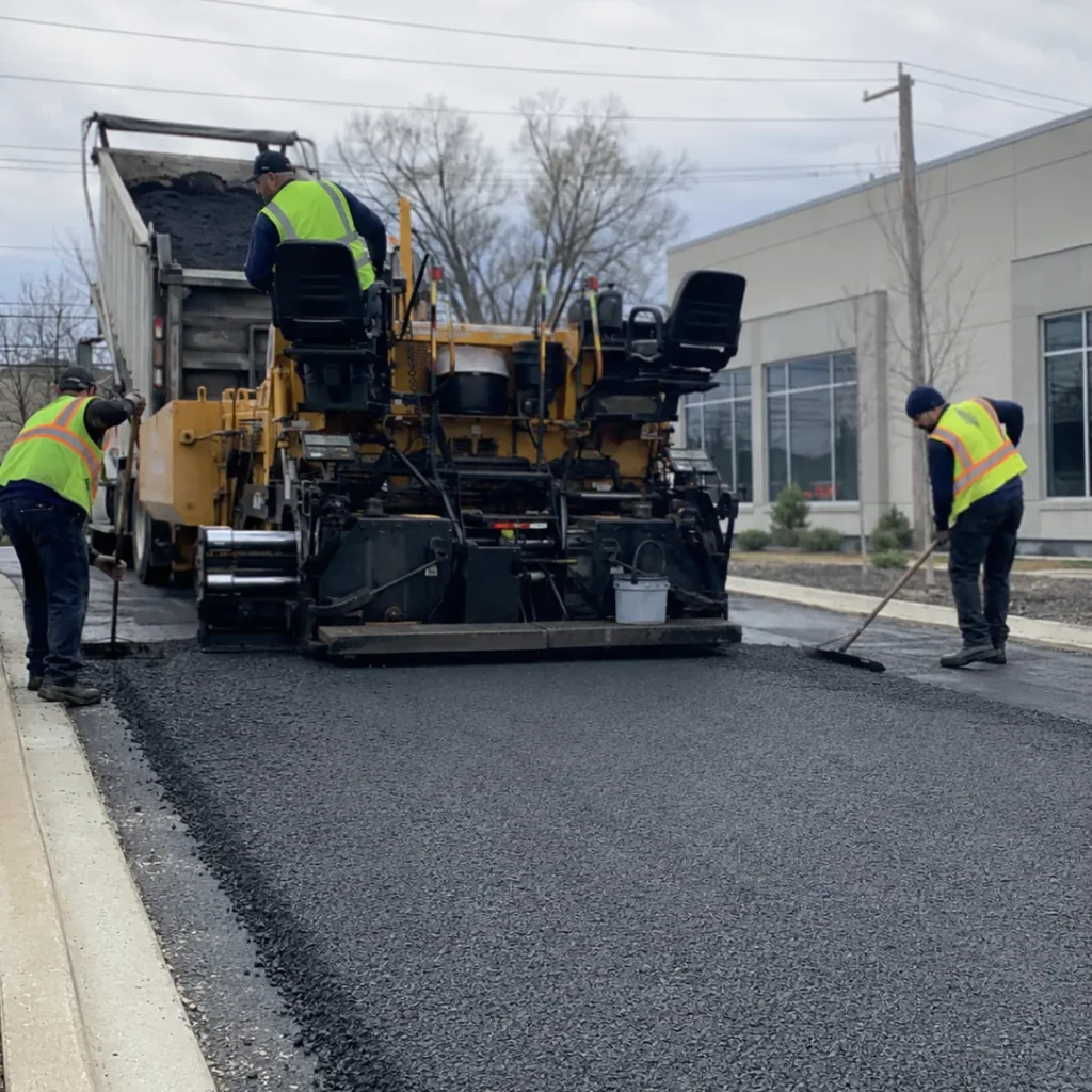 Paving Contractor checking surface grade beside a Coral Springs - FL driveway before installing pavers